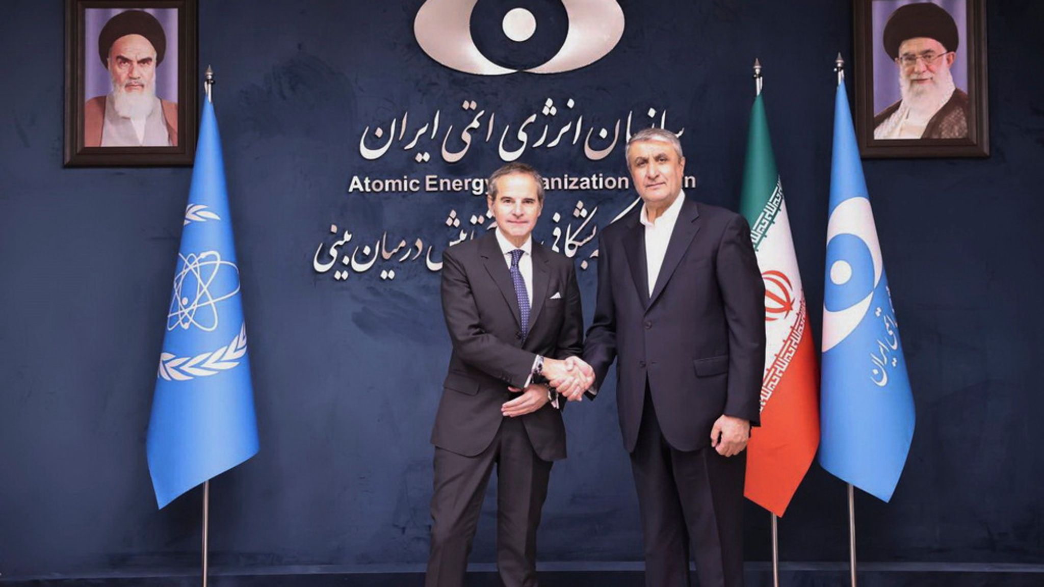 In this photo released by the Atomic Energy Organisation of Iran, International Atomic Energy Agency (IAEA) Director General, Rafael Mariano Grossi, left, shakes hands with head of the Atomic Energy Organization of Iran Mohammad Eslami, at the Atomic Energy Organisation of Iran, in Tehran, Iran, Thursday, April 17, 2025. (Atomic Energy Organisation of Iran via AP)